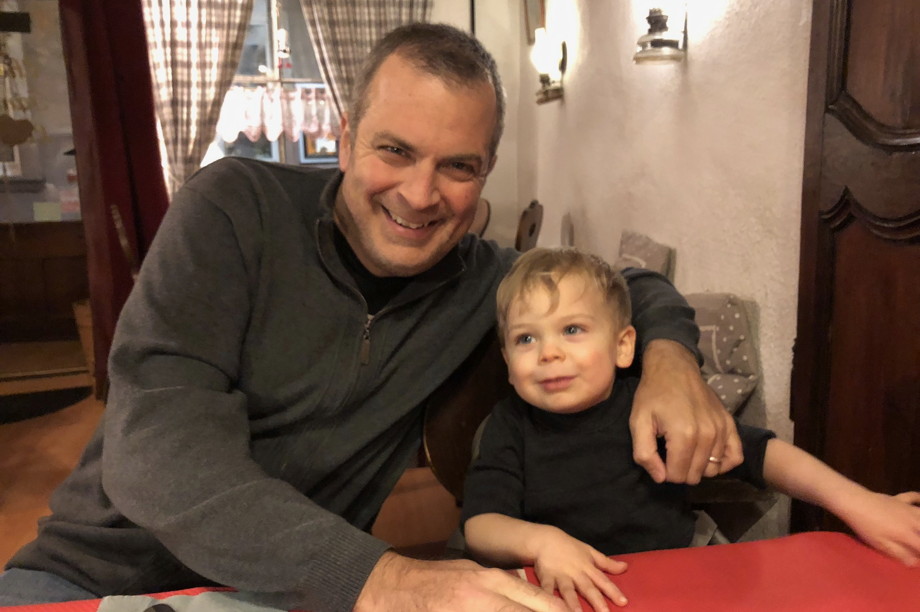 Father and young son in a restaurant, smiling for the camera