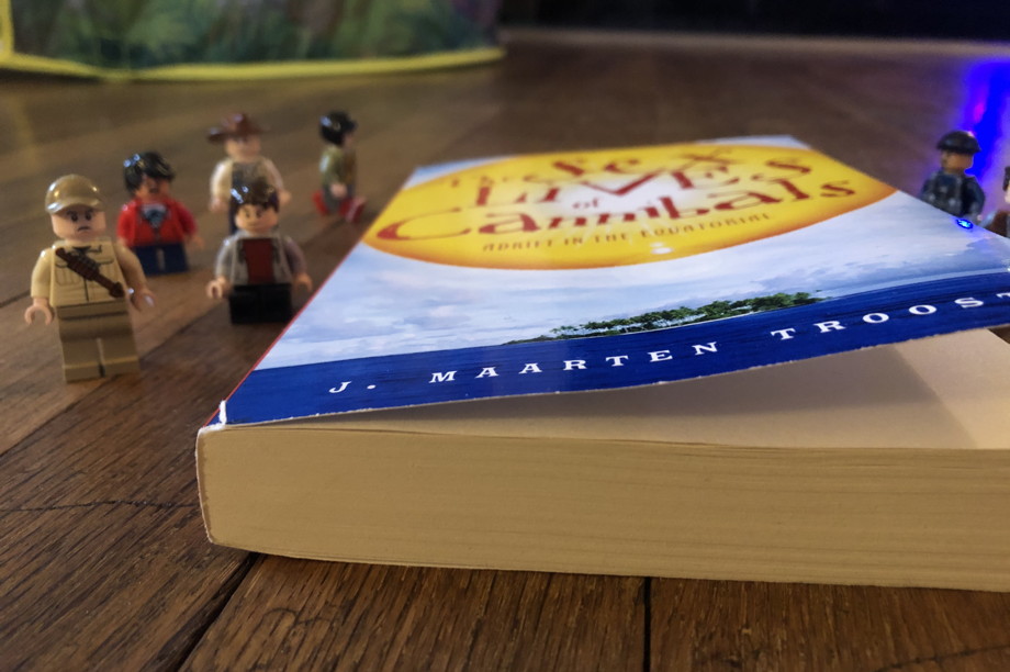 A book surrounded by Jurassic Park Lego characters