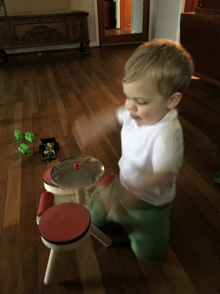 Toddler drumming so fast his arms are a blur