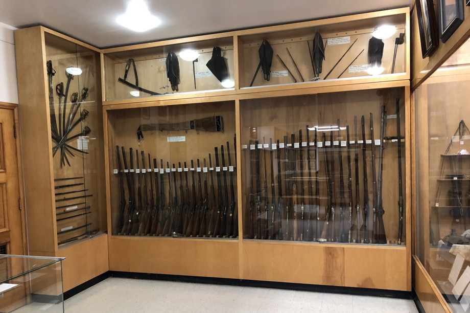 Shotguns and swords in a case