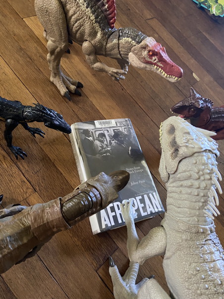 A book surrounded by dinosaurs