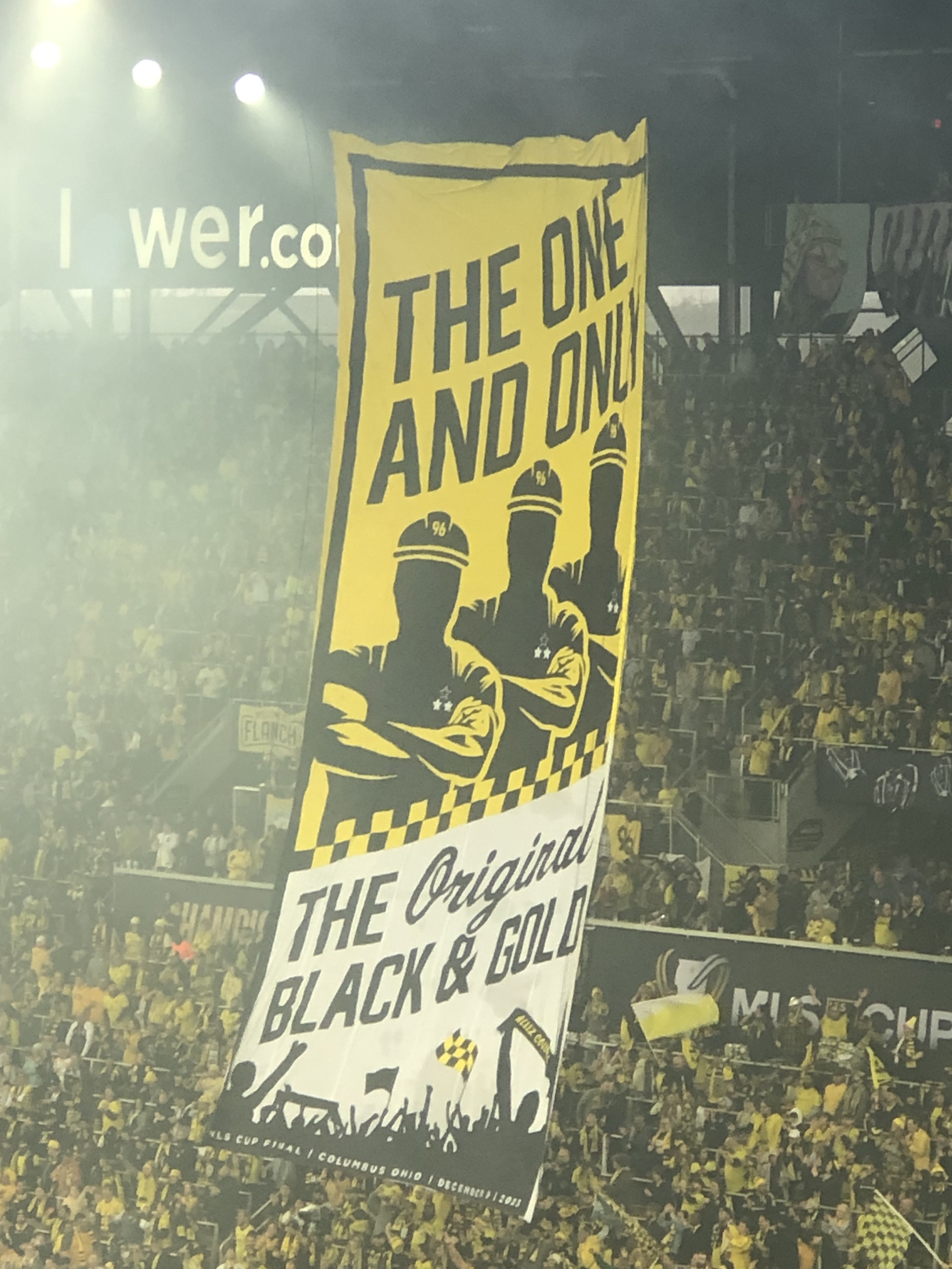 A black and gold banner with old school construction workers