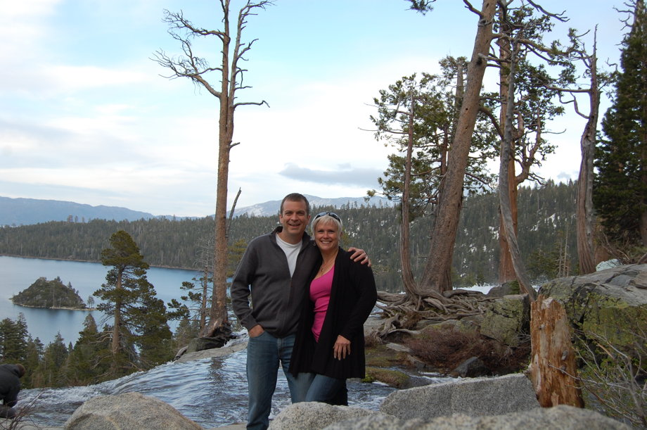 Ferociously attractive couple standing on rocks high above Emerald Bay