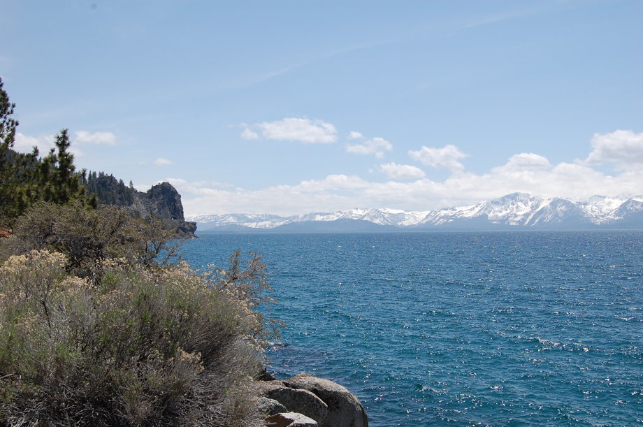 Turquoise blue water and snow-capped mountains in the distance