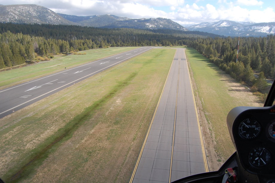 Boring airport runway, surrounded by pine trees