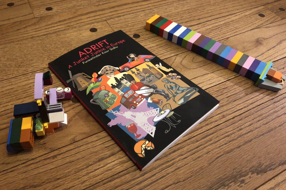 A book surrounded by Lego creations