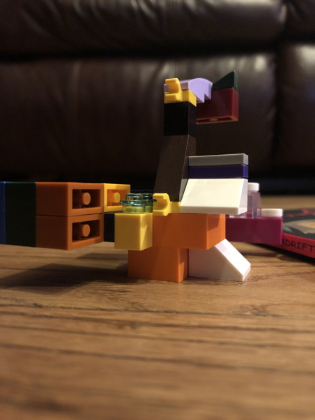 Several Lego bricks connected to create a beautiful abstract object, orange, white, and gray