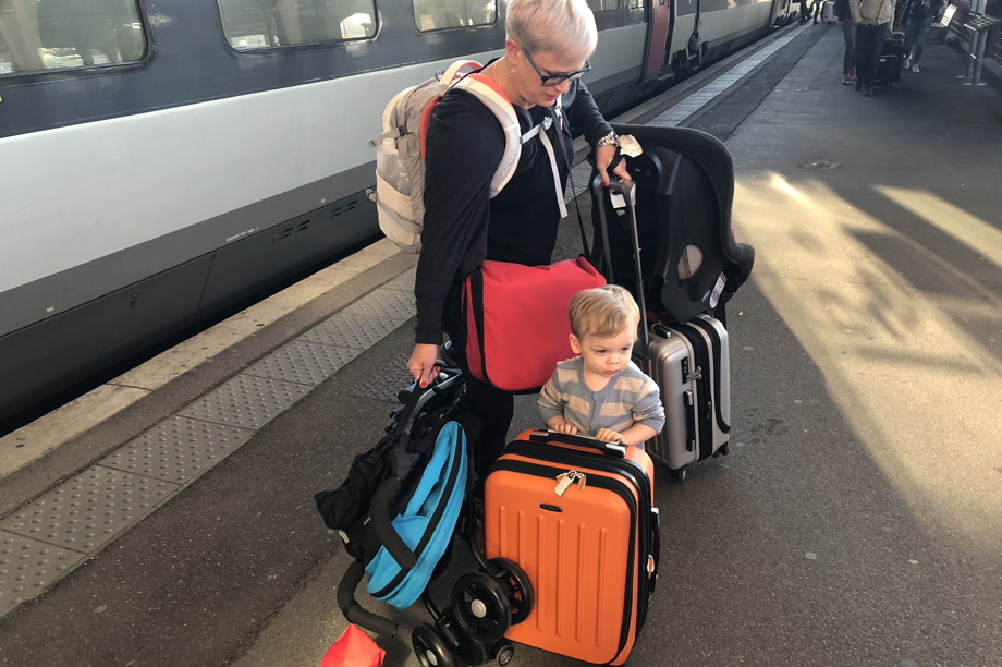 Mother with suitcases and child in pajamas