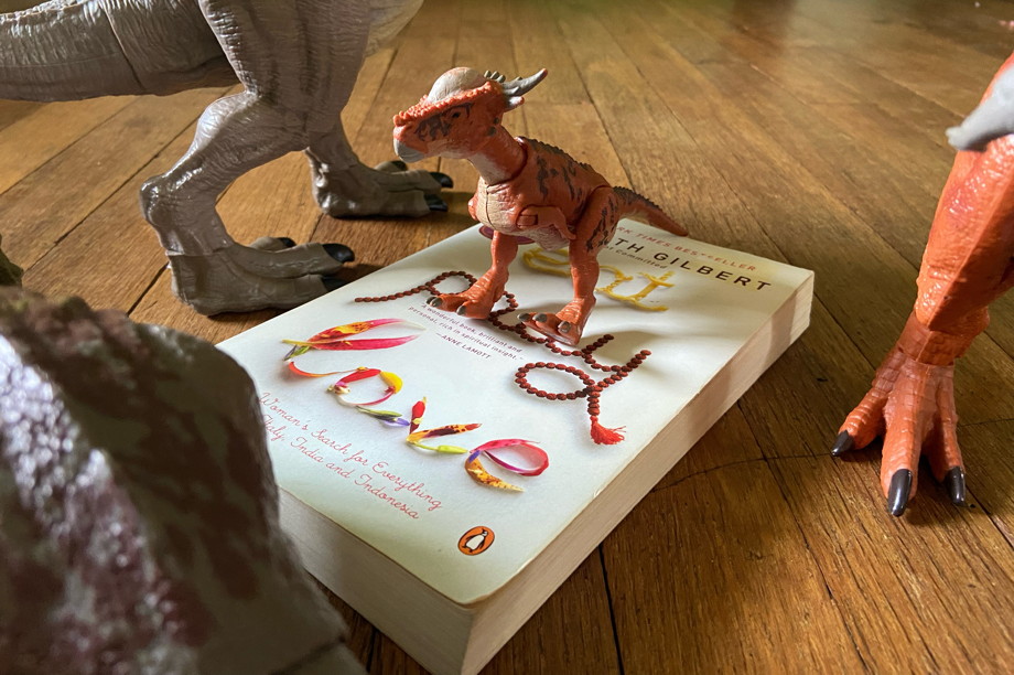 A book surrounded by menacing dinousaurs