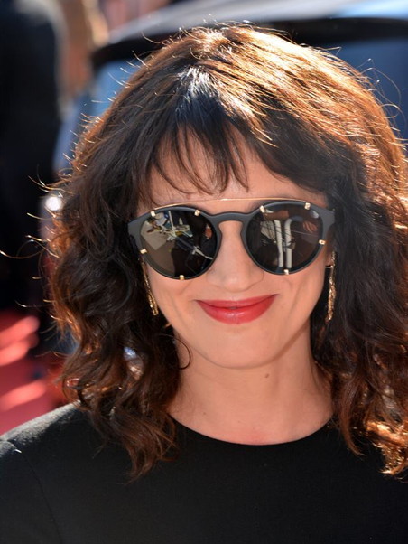 Smiling woman in sunglasses with red lipstick