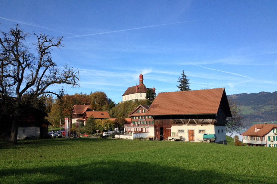 White church with brown roof and red spires