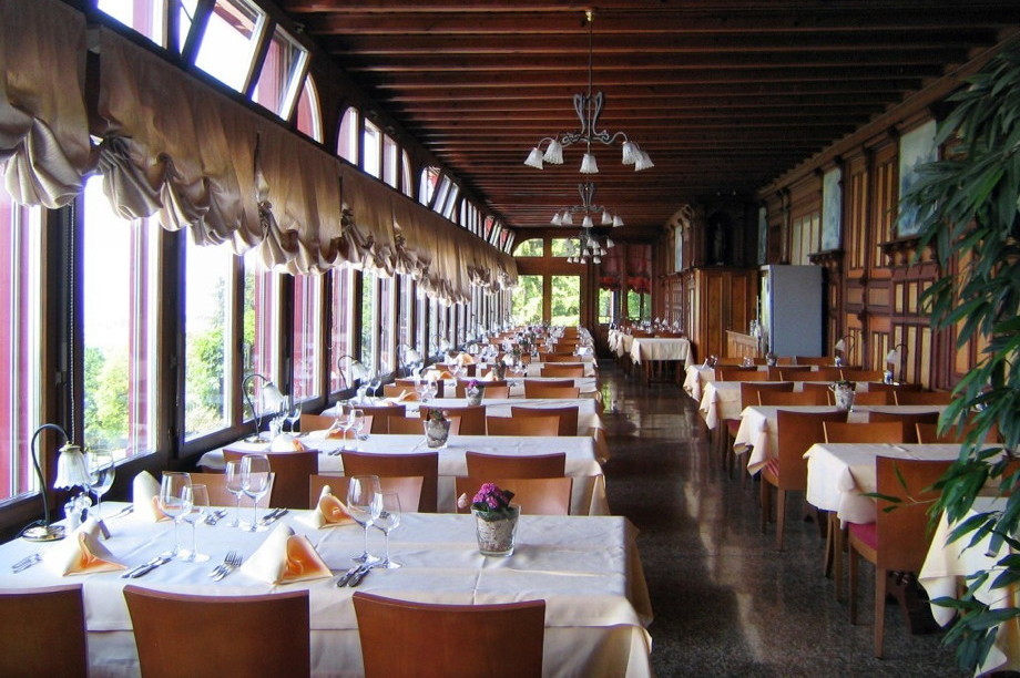 Long dining room with windows overlooking a valley