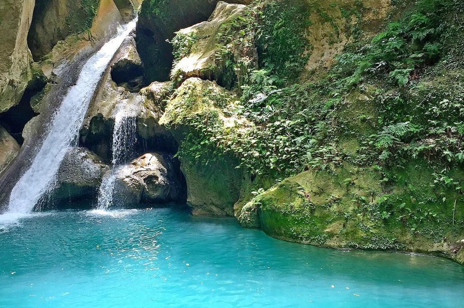 Luminous, turquoise swimming hole and a waterfall