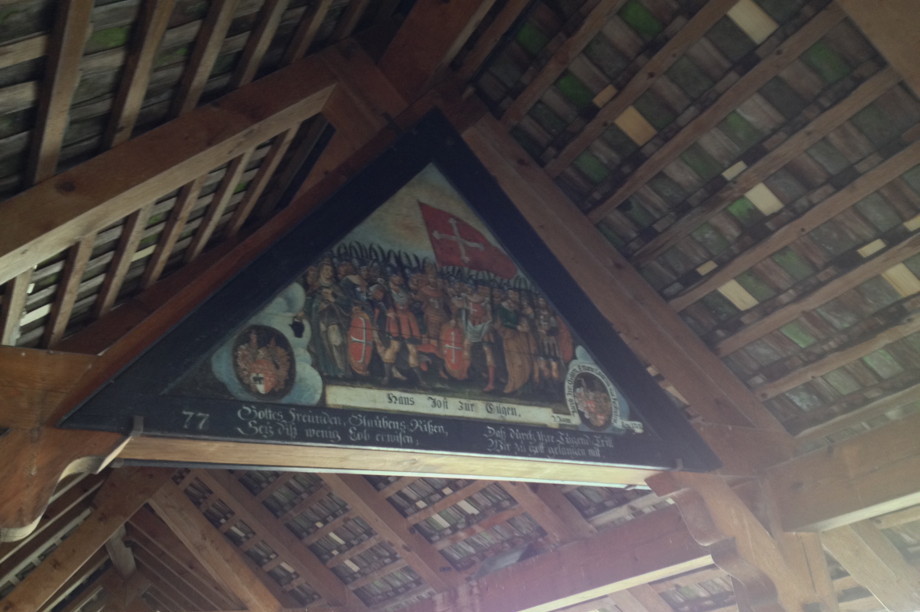A painting of soldiers tucked under the ceiling of an open air bridge