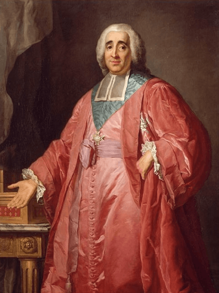 Gentleman in a red robe, pointing toward his desk