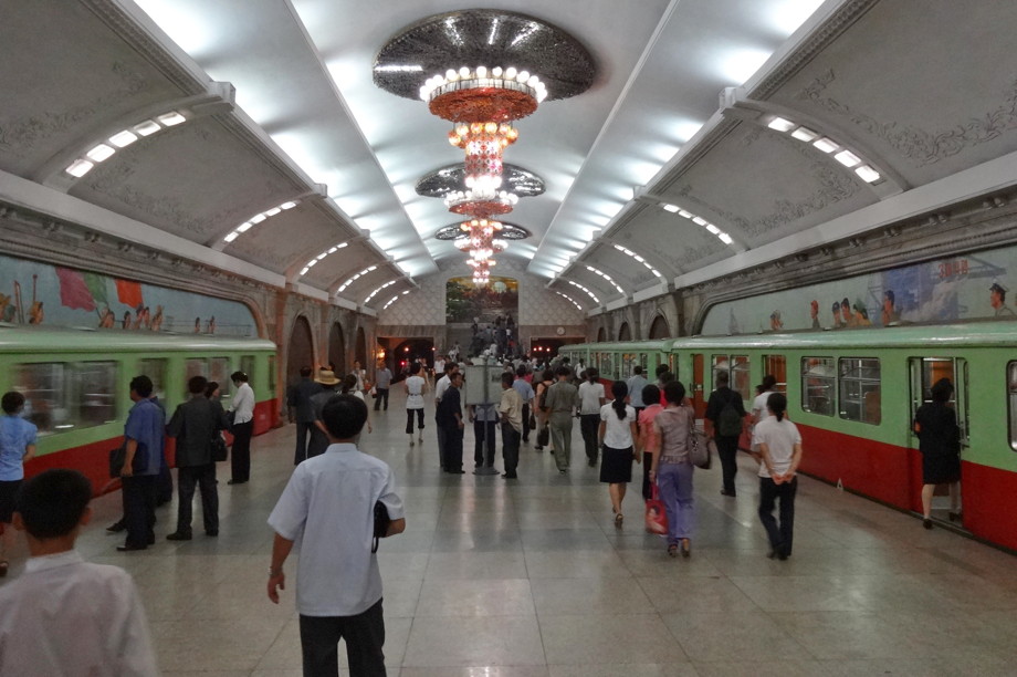 Bright, colorful metro station with well-maintained trains and chandeliers